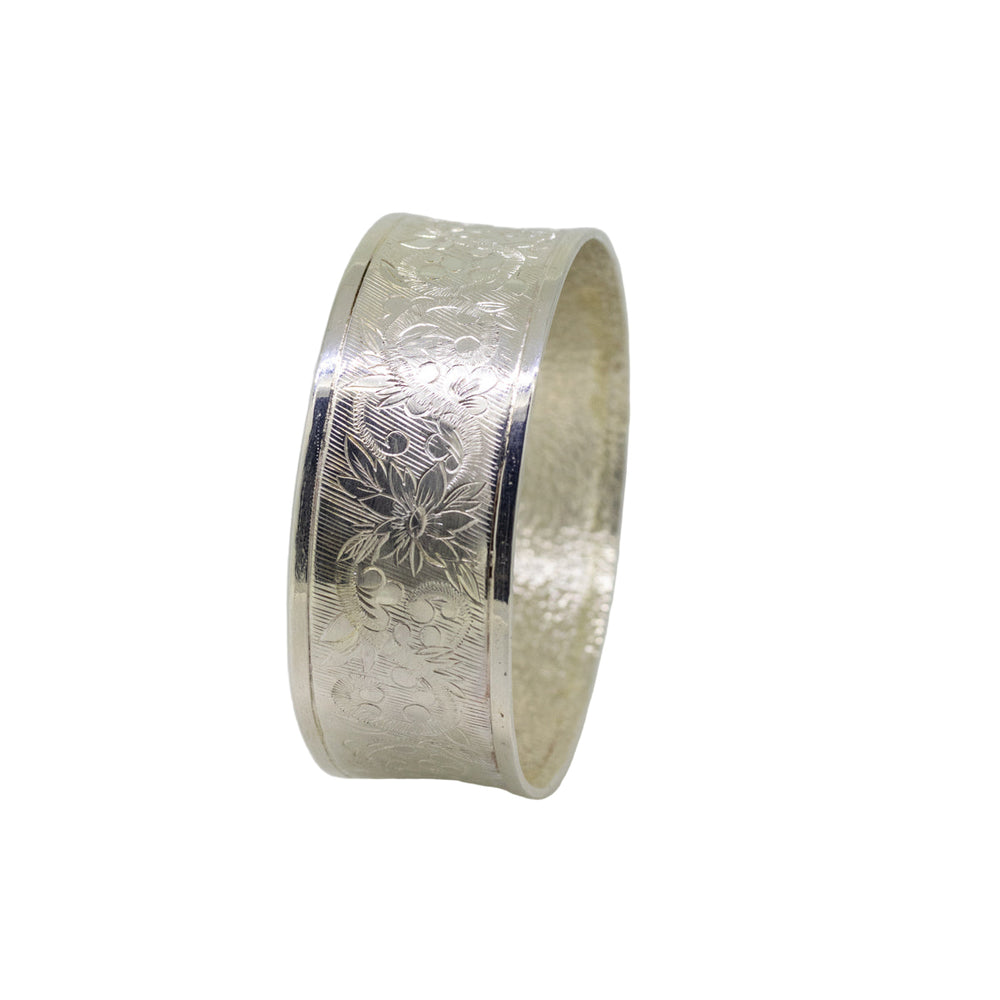 Silver bracelet with intricate designs on a white background