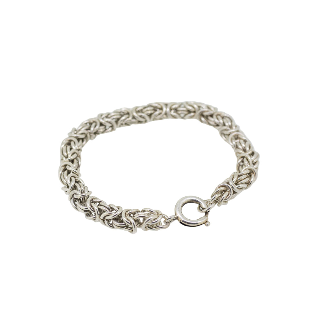 Silver braided bracelet on a white background