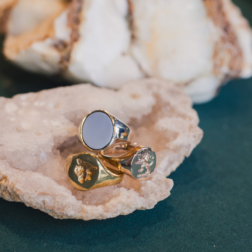 Gold and silver ring with engraved designs on a shell