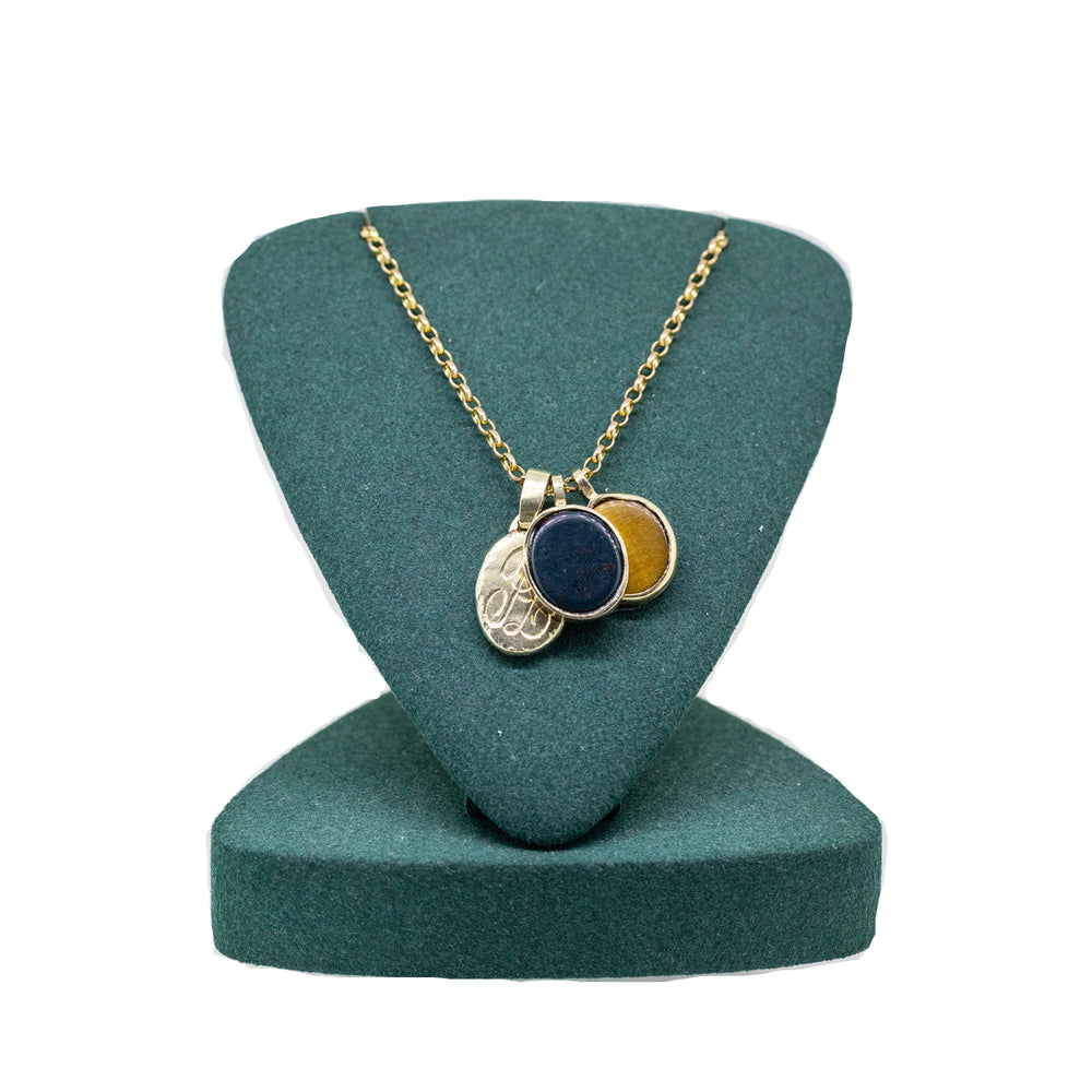 Gold necklace with a black pendant