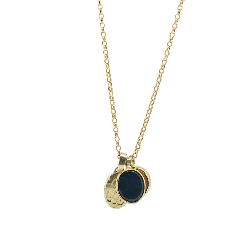 Gold necklace with a black pendant