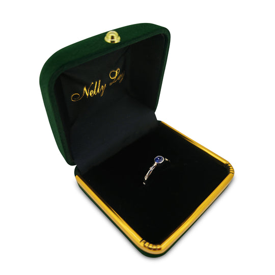 Open jewelry box with a ring inside, featuring the brand 'Nelly Le'.