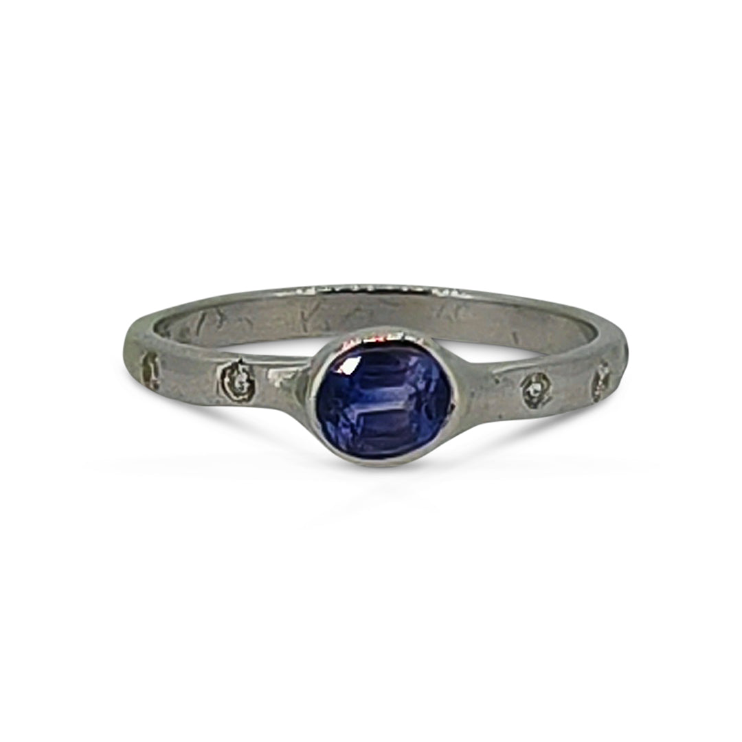 Silver ring with a blue gemstone on a white background