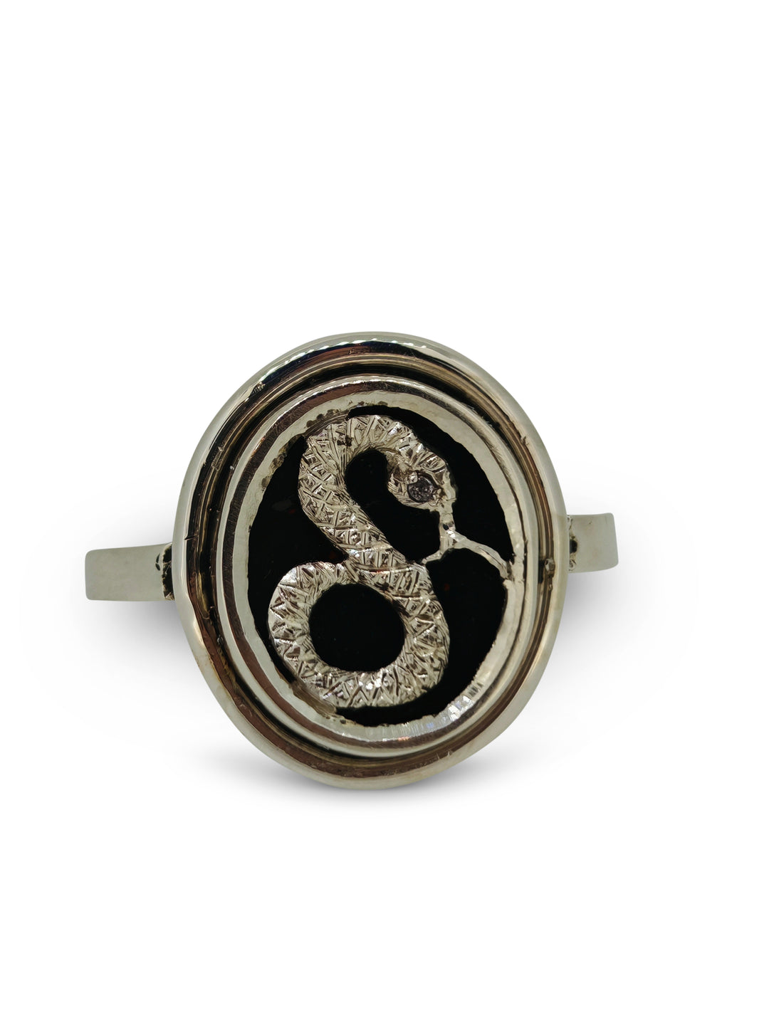 Silver ring with a black center and decorative design on a white background