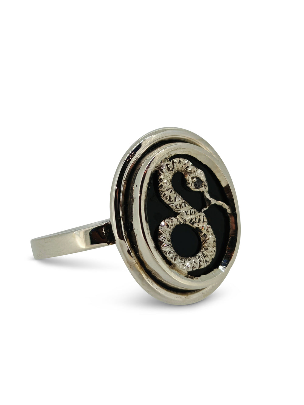 Silver ring with a black oval stone and a central gem on a white background