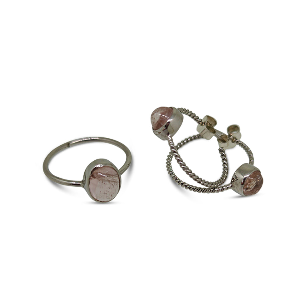 Two silver rings with pink gemstones on a white background